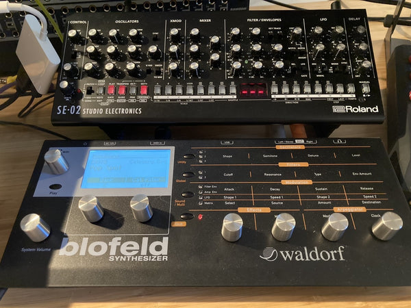SE-02 on Boo-1 desktop synth stand with room for cables of Blofeld to pass underneath.