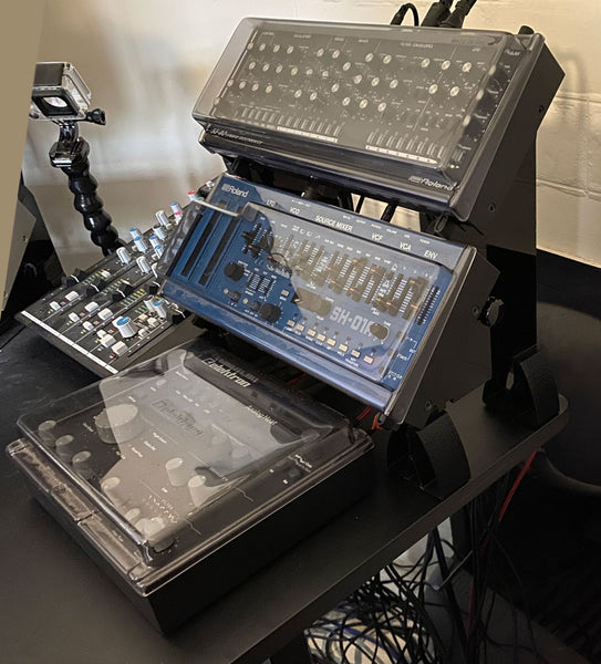 Stand for Roland Boutiques with Decksavers covers (KVgear Boo-2).  Elektron Heat fits on table in front.