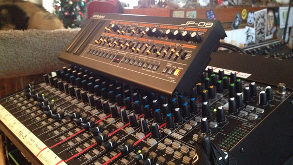 KVgear Stiletto Angled holds Roland Boutique above mixer knobs.