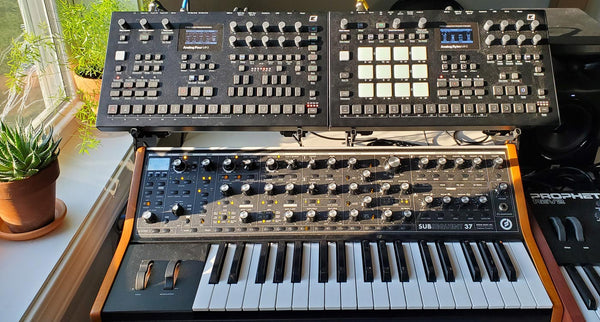 Two Elektrons (Analog Four MkII and Analog Rytm MkII) held above Moog Sub37 by KVgear SubPiggy stand