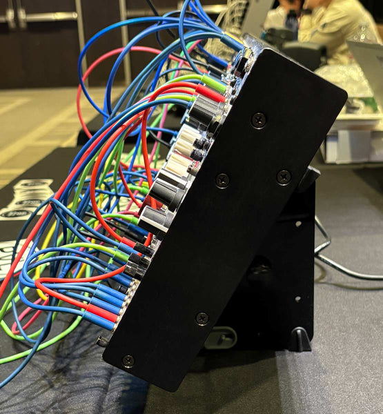 Side view of SynthRISE modular synth stand with Intellijel case.